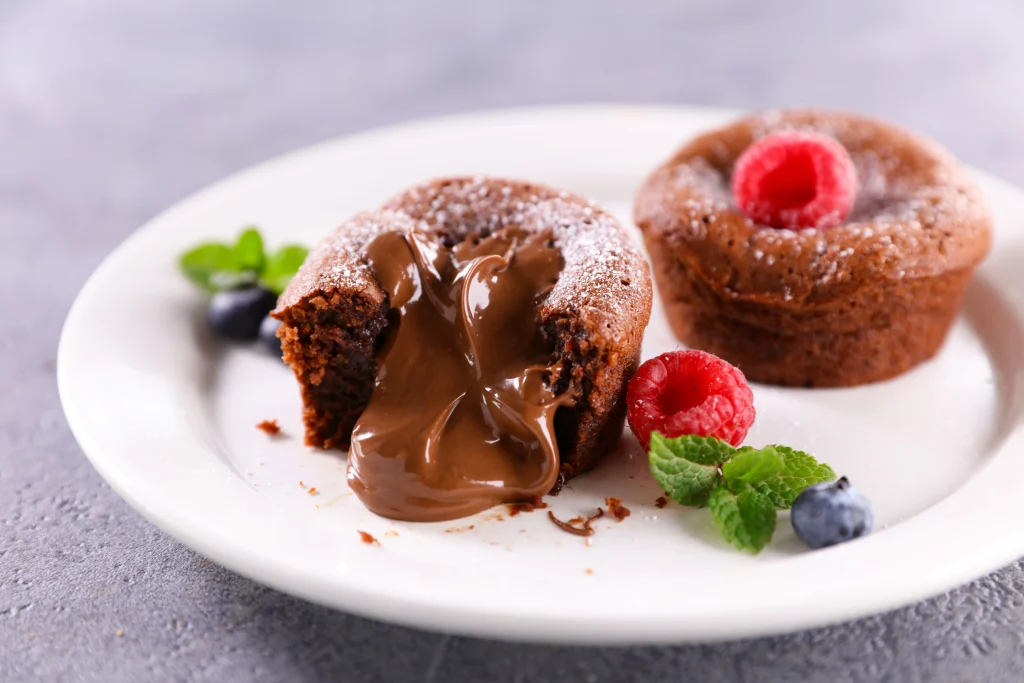 Best Party Desserts Chocolate lava cake with molten chocolate center served with berries