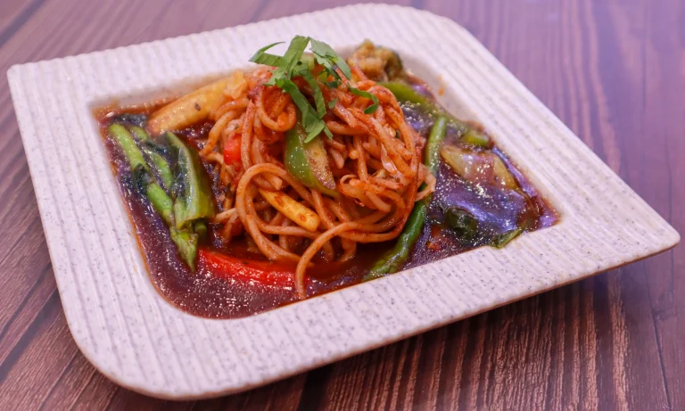Fusion vegetable noodles with colorful bell peppers and Asian-style sauce