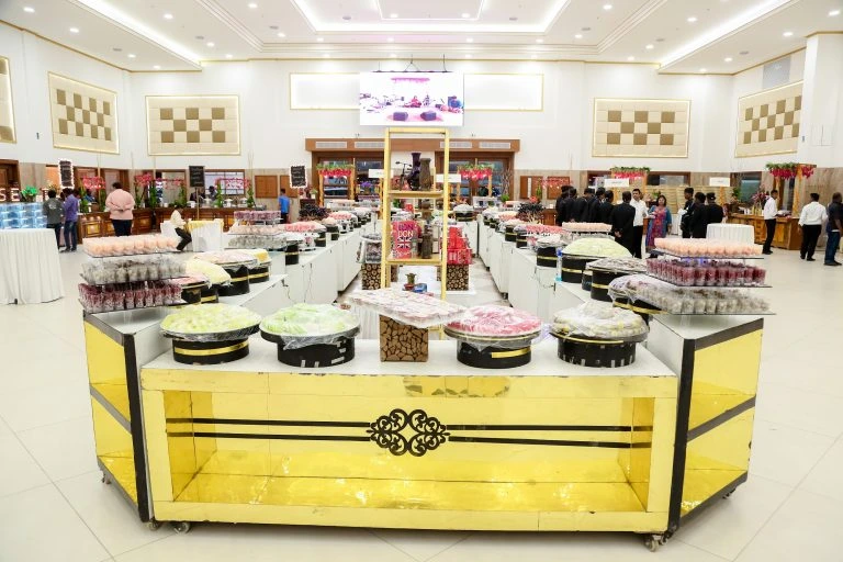 A grand indoor wedding sweet and dessert buffet station by Sarvsri in Chennai