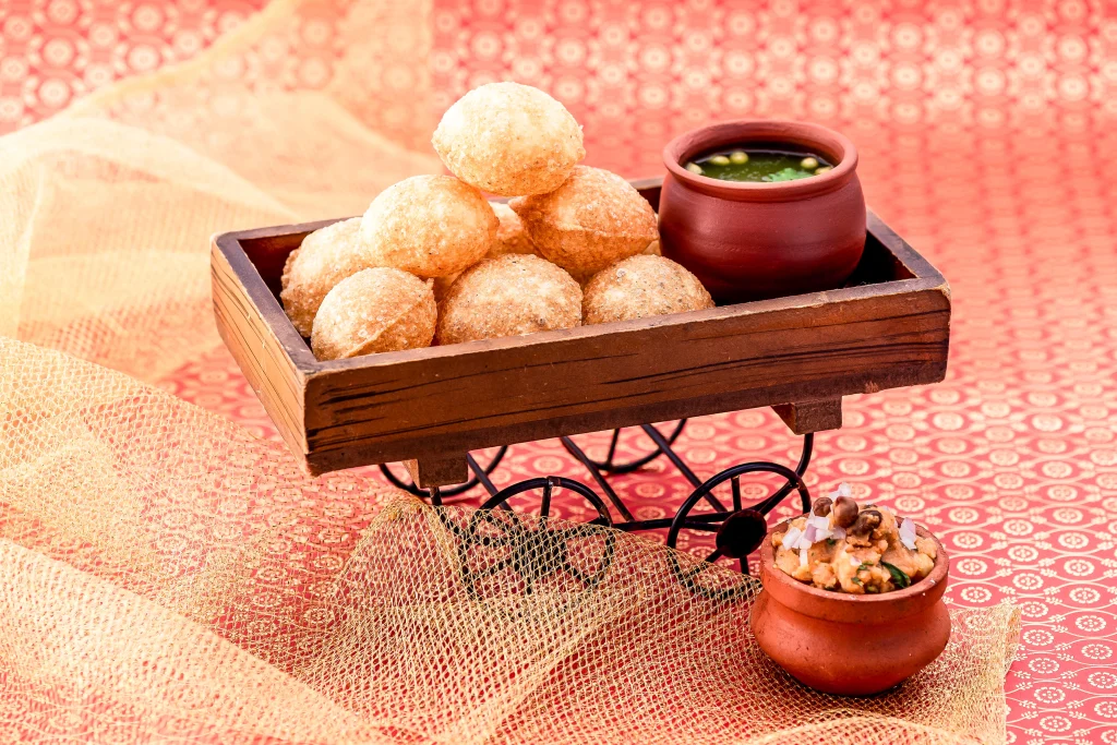 Crispy pani puri served with spicy mint water and potato chickpea filling made for great Indian chaat food