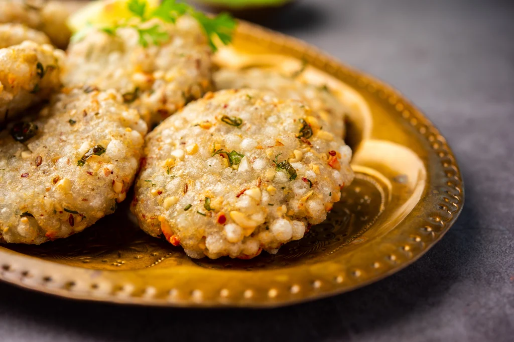 Sabudana vada crispy fritters made from tapioca pearls, peanuts, and potatoes served on a plate