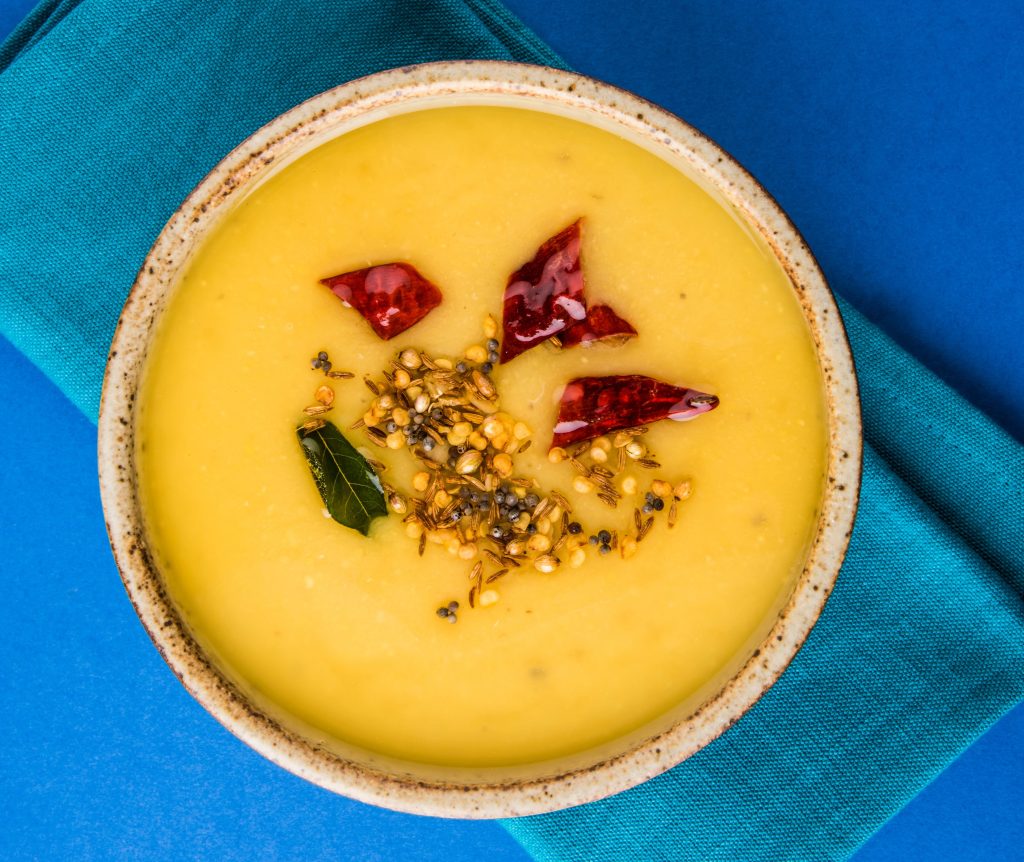 Traditional South Indian Mor Kuzhambu tempered with mustard seeds, cumin, and dried red chilies