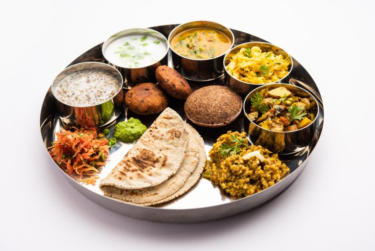 Authentic vegetarian millet thali with vegetable dishes, and naan served as part of premium Veg Catering Services