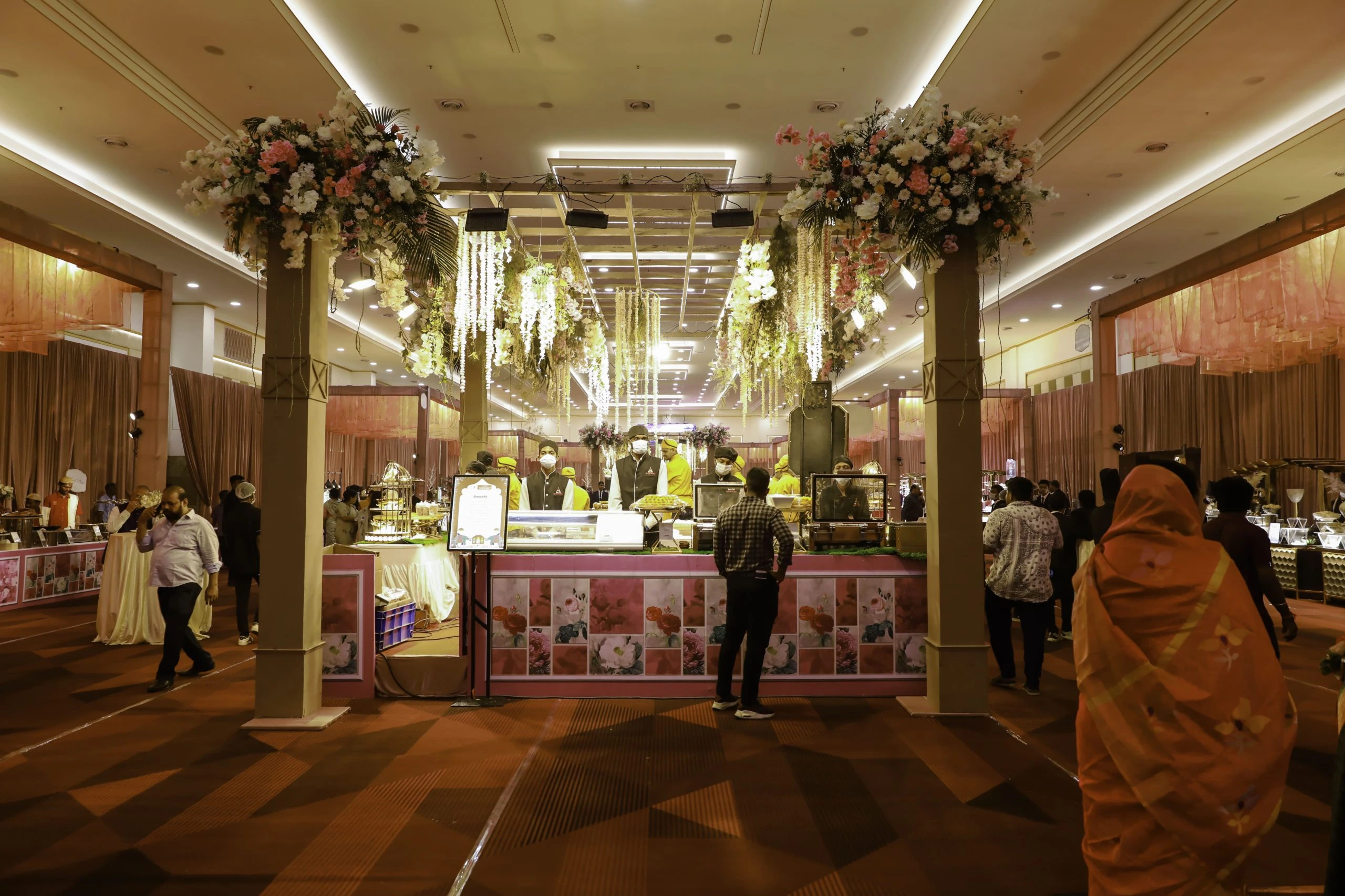 Stunning catering setup with exquisite floral arrangements, ideal for large events and celebrations.