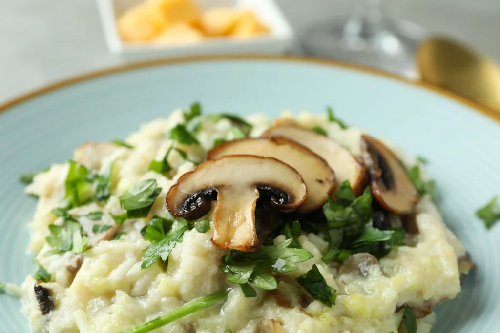 Creamy mushroom risotto garnished with fresh parsley and sliced mushrooms served by Sar v Sri Continental Catering Services