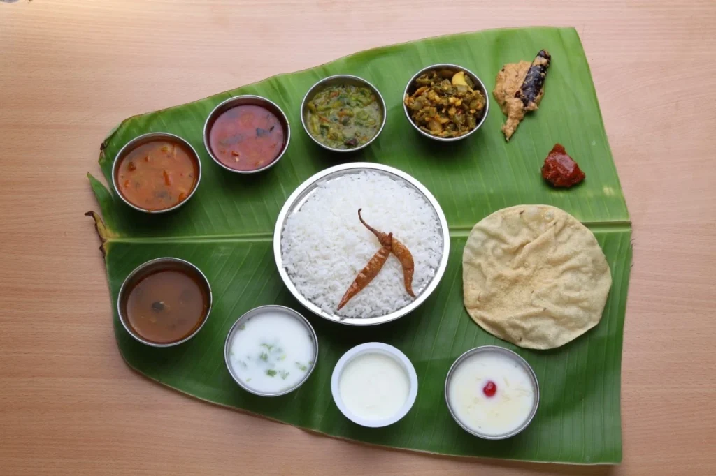 Delicious Andhra meal with rice, curries, chutneys, and papad served on banana leaf by andhra catering services in chennai