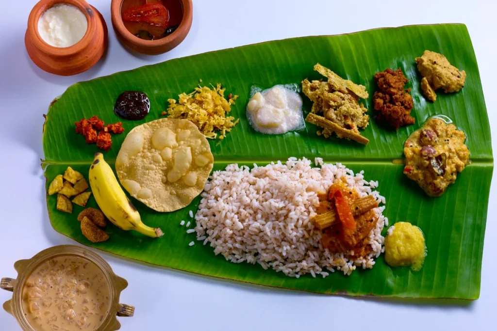 Kerala Sadya served on banana leaf with rice and traditional dishes by Sar V Sri Kerala Catering Services