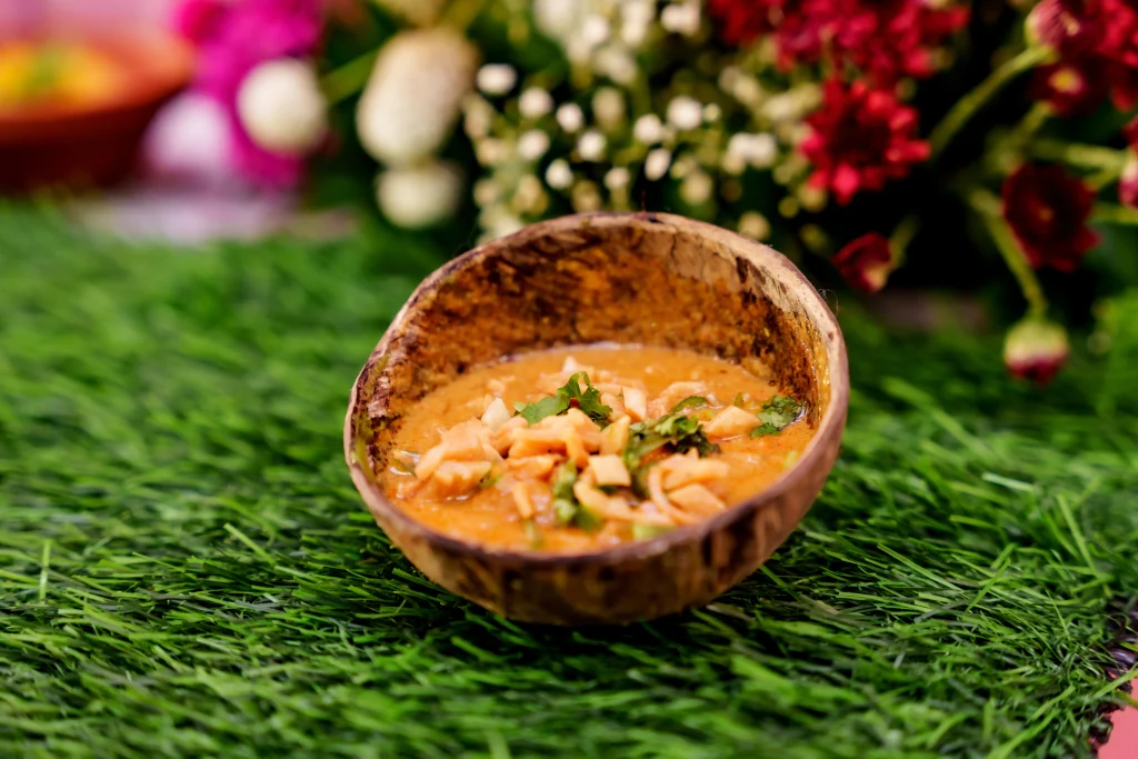 Street style paneer curry served in a coconut shell bowl by Sar V Sri street food caterers