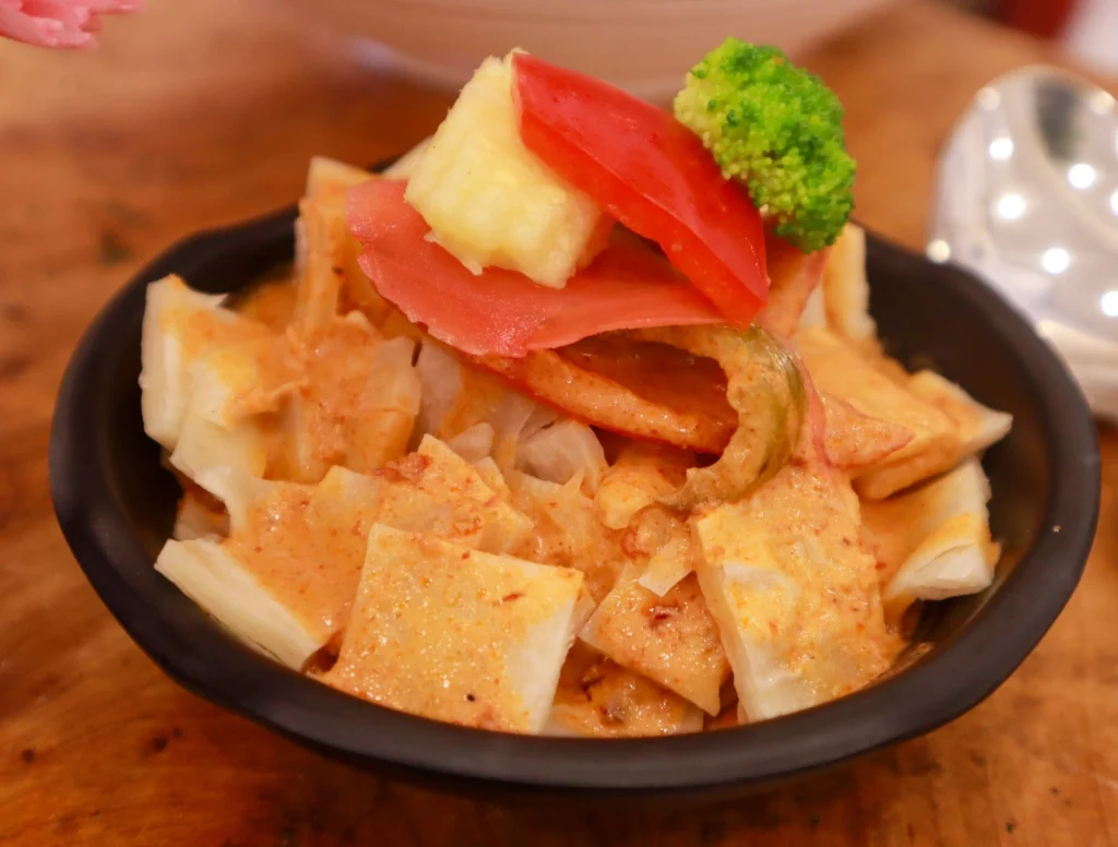 Authentic Pan Asian vegetable curry with tofu, bell peppers, and broccoli served in a bowl