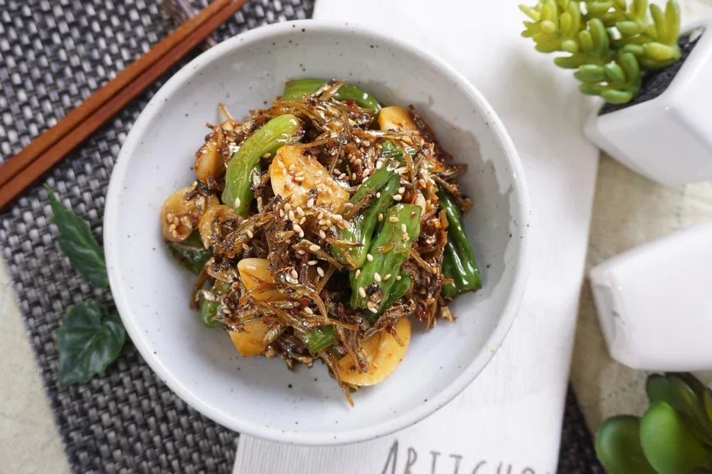 Delicious Pan Asian stir-fried vegetables with garlic, sesame seeds, and crispy toppings served in a bowl