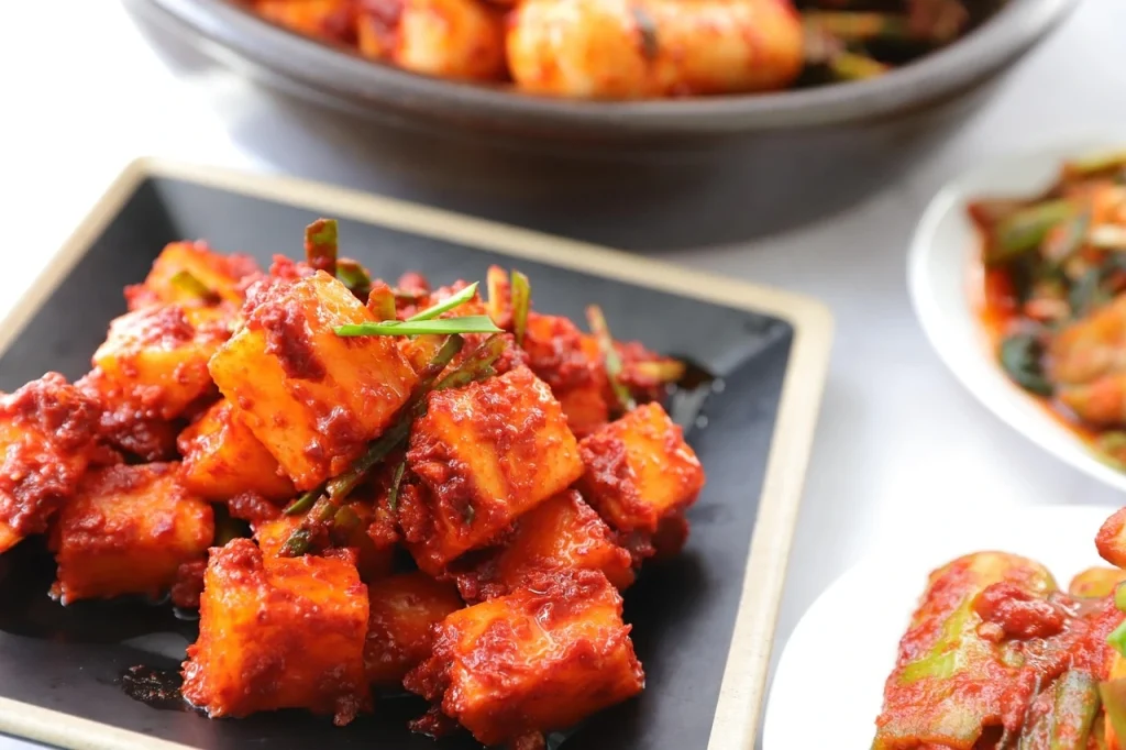 Korean Kimchi with tofu and vegetables, marinated in spicy red chili paste