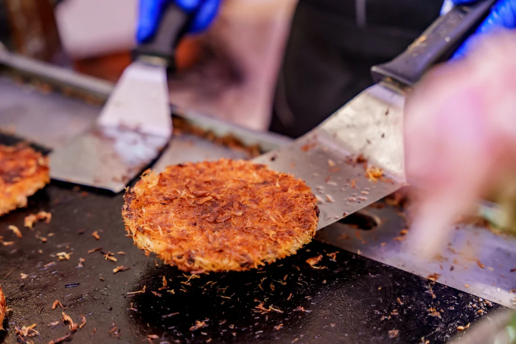 Lebanese Kunafa dessert being freshly prepared on a hot griddle