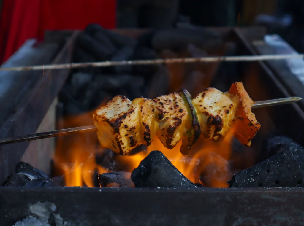 Lebanese grilled paneer shish skewers cooked over charcoal fire