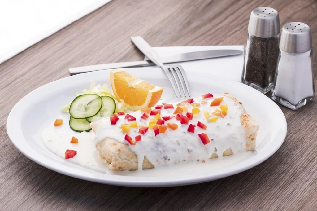 Mexican veg burrito served with salad and lemon