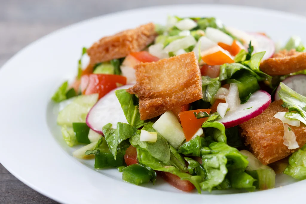 Traditional Lebanese Fattoush salad served on a white plate