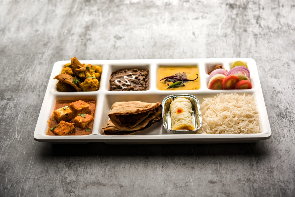 Meal Box Delivery featuring Paneer curry, Dal Makhani, Dal Tadka, Aloo Gobi, Roti, Rice, and dessert for corporate catering