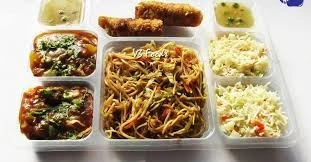 Sar V Sri Catering meal box Delivery featuring vegetable noodles, fried rice, Manchurian gravy, and appetizers