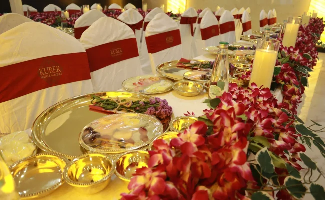 Sophisticated reception dining table setup with floral decor and gold-plated tableware for a premium event by Sar V Sri